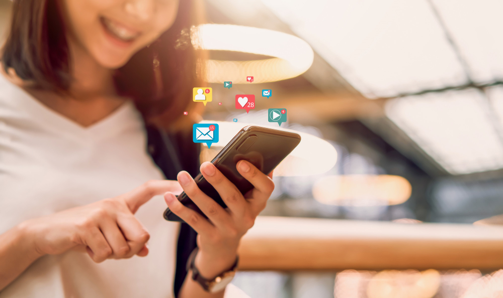 social-media-and-digital-online-smiling-asian-woman-using-smartphone-and-show-technology-icon